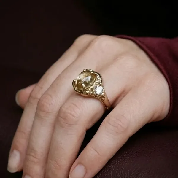 Amplyar AI on-model photo of the vintage ring worn on a hand, close-up macro framing