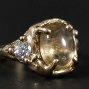 SellerPic AI studio photo of the vintage ring on a black background